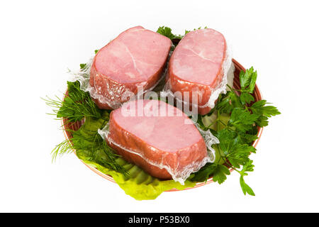 Cou de porc fumé avec des greens posés sur un plateau. Banque D'Images