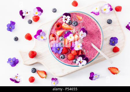 Smoothie d'été saine berry bowl avec fleurs et semences chia Banque D'Images