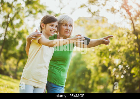 Grand-mère et petite-fille prennent des photos dans le parc. Banque D'Images