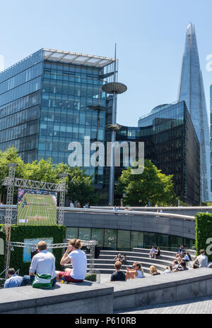 Lond, Royaume-Uni, 27 juin 2018. La canicule se poursuit dans le centre de Londres avec un ciel bleu et des températures record potentiellement. Des foules de touristes et les employés de bureau à Londres plus de place et le Tower Bridge profitant du temps chaud et du soleil assis sur l'herbe et le soleil. Crédit : Steve Hawkins Photography/Alamy Live News Banque D'Images