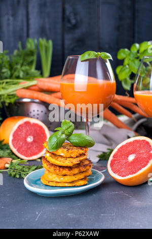 À partir de jus de carottes fraîches et de pamplemousse dans un verre et parfumé des crêpes pour le petit-déjeuner. vitamine boire pour un régime alimentaire sain. Les vitamines dans l'alimentation. Copy space Banque D'Images