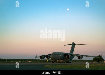 Un C-17 Globemaster III, exerçant son activité sous marines des États-Unis avec l'Escadron d'hélicoptères d'attaque légère Marine 367 Marine Aviation et de l'escadron 24 de la logistique, ainsi qu'un hélicoptère UH-1Y Venom, des terres au Royal Australian Air Force Base Darwin, Australie, le 20 avril 2016. Les Marines, agissant en tant qu'élément d'un combat de l'Aviation 1 250 Marine membre du groupe de travail, la capacité air-sol fournira un appui aérien aux forces de rotation maritime - Darwin avec quatre hélicoptères UH-1Y Venom. MRF-D est un déploiement de six mois de Marines dans Darwin, Australie, où ils pourront effectuer des exercices et former avec l'Australian Defence Banque D'Images