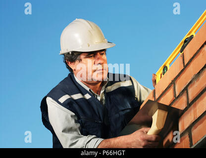 Travailleur du bâtiment pose de briques Banque D'Images