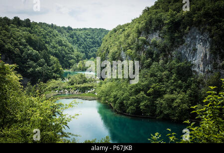 Superbe vue aérienne du Parc National de Plitvice beaux lacs sur une chaude journée d'été, entouré par des falaises. Une petite chute d'eau entre les lacs. Banque D'Images