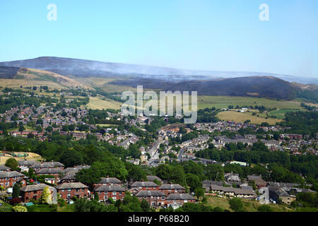 Tameside Moor, Manchester, UK - 28 juin 2018. Le Bellevue Moor wildfire continue à brûler le jeudi après-midi avec des pompiers à l'aide d'un godet d'hélicoptère pour essayer d'éteindre le feu et obtenir le feu. Crédit : Andrew Gardner/Alamy Live News Banque D'Images