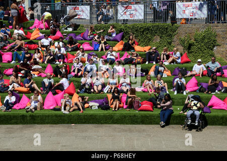 Grenier Square. Londres. Royaume-uni 29 juin 2018 - les travailleurs de la ville et les touristes profiter une autre journée chaude dans le grenier Square, Londres près de Regents Canal assis sur des coussins colorés tout en regardant le Roi Lion film sur un grand écran LED. Selon le Met Office, Juin a été le mois le plus sec jamais enregistré. Credit : Dinendra Haria/Alamy Live News Banque D'Images