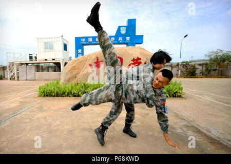 (180629) -- JUBA, 29 juin 2018 (Xinhua) -- Le soldat chinois Yu Peijie (retour) se débat avec un soldat au camp de bataillon d'infanterie de maintien de chinois pour le Soudan du Sud le 30 avril 2018. Peijie Yu, 26 ans, est le chef de l'unité de soldat de la femelle d'infanterie bataillon de maintien de la paix chinois au Soudan du Sud. Elle a un surnom appelé 'strong frère aîné." Cependant, elle a aussi un coeur doux. Cette année marque le 70e anniversaire du maintien de la paix des Nations Unies. La Chine a commencé ses participations dans les opérations de maintien de la paix des Nations Unies en 1990. Aujourd'hui, la Chine a quelque 2 500 casques bleus et joue un importer Banque D'Images