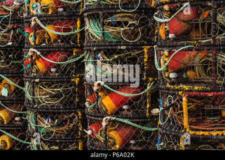 Gros plan de vol en crabe pots empilés de façon uniforme dans une rangée près d'un bâtiment dans la région de Newport sur la côte de l'oregon dans une baie. Banque D'Images