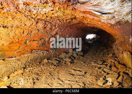 Craggy roches formant une grotte de lave éclairés par la lumière artificielle, capturés lors d'une exposition longue durée offre contrastée couleurs orange, l'islande avril 2018 Banque D'Images