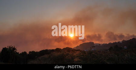 West Pennine Moors , Royaume-Uni, 29 juin 2018. Les incendies autour de Rivington Pike et Winter Hill à l'Ouest le ciel Pennine Moors remplir de fumée, à la dérive sur les villes ci-dessous tout en fin de soirée, Sun continue à briller fortement et la longue période de sécheresse se poursuit avec aucun signe de décomposition. Banque D'Images