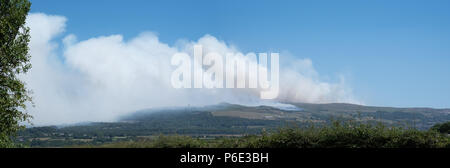 Rivington Pike, UK, 30 juin 2018. L'ampleur des incendies et de la fumée sur le côté ouest de l'Ouest Pennine Moors est clair sur ce panorama photo de l'ensemble de la colline d'hiver et Rivington Pike colline.prise le samedi 30/6/2018 après au moins trois jours de brûler au cours d'une période de rupture record de chaud, sec et ensoleillé.La fumée a frappé les villes de Chorley, Horwich et Bolton ci-dessous. Credit : Ruaux/Alamy Live News Banque D'Images