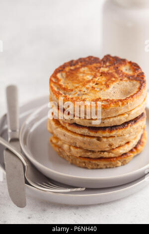 Pancakes vegan avec chia graines sur une assiette blanche, fond blanc. La nourriture végétalienne saine concept. Banque D'Images