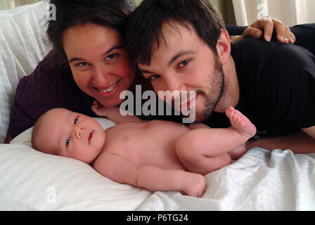 Happy smiling parents regardant adoringly leur bébé Banque D'Images