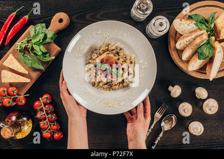 Portrait of woman putting plaque avec des pâtes sur le tableau Banque D'Images