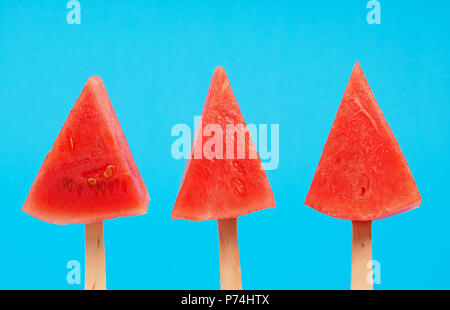 Trois watermelon pop sur un fond bleu, rafraîchissement ou une alimentation saine food concept Banque D'Images