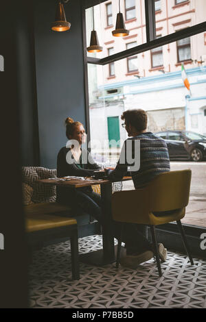 Couple de parler les uns aux autres dans le café Banque D'Images