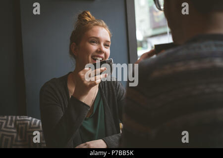 Smiling couple having coffee au café