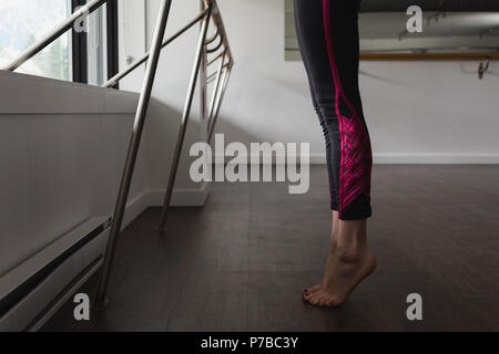 Jeune femme debout sur la pointe des pieds Banque D'Images