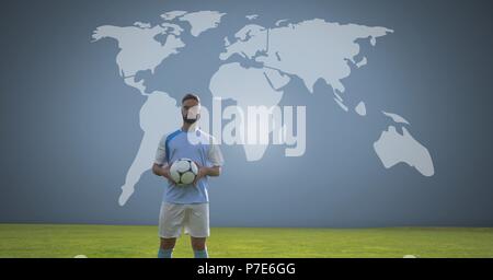 Soccer player holding football avec carte du monde Banque D'Images