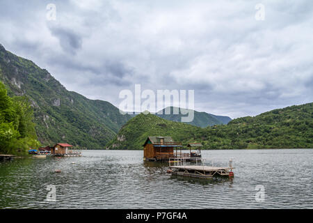 Fishemen maisons flottantes sur le lac Perucac, sur la rivière Drina, à l'ouest de la Serbie, entouré d'une vallée et étroit canyon et une forêt de pin tr Banque D'Images