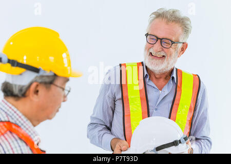 Mélanger la race des hauts ingénieurs en construction worker talking ensemble sourire heureux de travailler avec hard hat Banque D'Images