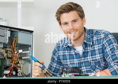 Portrait de technicien en informatique holding fer à souder Banque D'Images