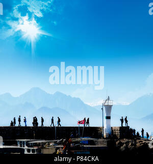 La silhouette du people relaxing à Antalya hébergent plus de ciel bleu et de hautes montagnes Banque D'Images