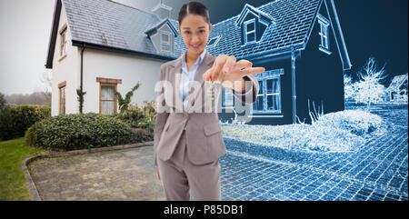 Composite image of smiling businesswoman holding une clé Banque D'Images