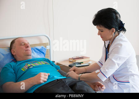 Biélorussie, Minsk, 24 avril 2018. L'Hôpital Central de Gomel.Le médecin mesure la pression sur le patient Banque D'Images