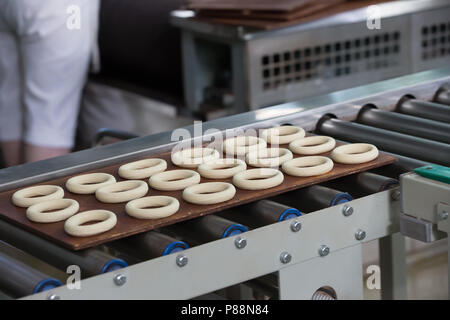 La ligne industrielle pour la fabrication de biscuits et des bagels. Convoyeur à bande pour la production de produits culinaires Banque D'Images