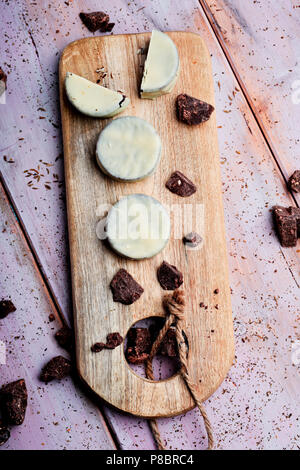 Portrait de certains argentine-uruguayen alfajores rempli de dulce de leche et recouverts d'une couche blanche sur une planche en bois, sur une ru Banque D'Images