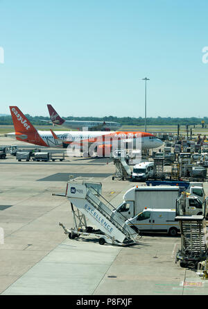 Un Airbus A320 G-UZHB EasyJet en stand et un taxi Virgin Atlantic A330 G-VMNK à l'aéroport international de Manchester Grande Angleterre Banque D'Images