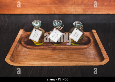Set of massage oil on wooden plate in tropical spa in Bali. For relaxation, meditation and inspiration Banque D'Images