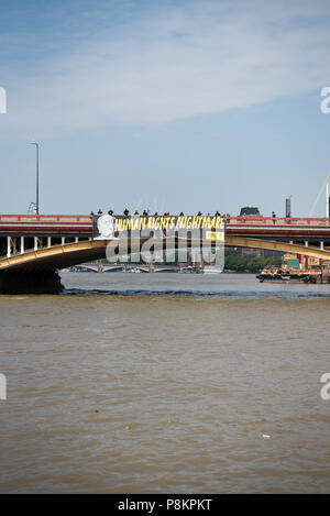 Londres, Royaume-Uni. 12 juillet, 2018. Amnesty International se déploient une bannière de protestation géante sur Vauxhall Bridge à Londres avant l'arrivée au Royaume-Uni du président américain Donald Trump. La bannière face vers l'ambassade des Etats-Unis et porte la mention "cauchemar" des droits de l'homme ainsi qu'une grande image de Donald Trump. Credit : Ilyas Ayub / Alamy Live News Banque D'Images