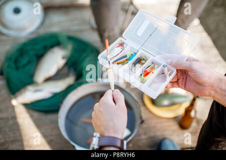 Fisherman holding box avec des matériels de pêche au cours de l'aire de pique-nique en plein air, close-up view Banque D'Images