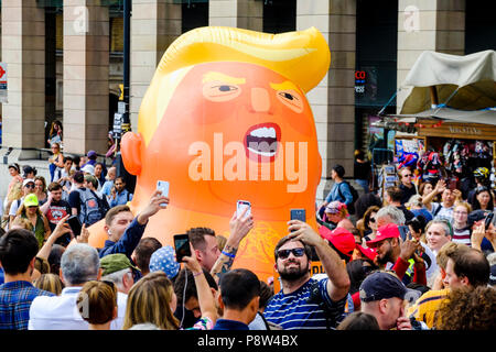 Londres, Royaume-Uni. 13 juillet 2018. Des dizaines de milliers de personnes sont descendues dans les rues du centre de Londres pour protester contre le président américain, Donald Trump à l'occasion de sa visite au Royaume-Uni. Sur la photo : Les gens prennent vos autoportraits avec bébé au cours de la London gonflable Trump démonstration. Banque D'Images
