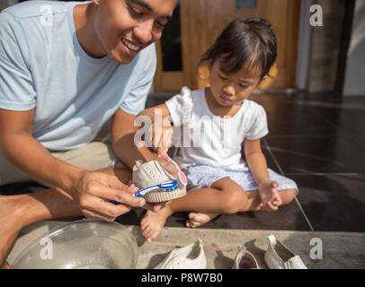 Portrait de père et fille chaussures Nettoyage ensemble. La parentalité positive concept Banque D'Images