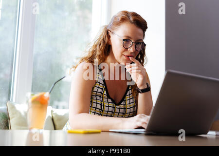 Belle rousse femme travailleur à distance sentiment réfléchi Banque D'Images