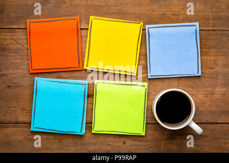 Série de notes de rappel coloré en blanc, sur une table en bois grunge avec une tasse de café expresso Banque D'Images