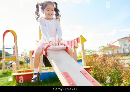 Cute Asian Girl on Playground Banque D'Images