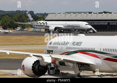 Farnborough, Royaume-Uni. 16 juillet 2018. Un Boeing 787-800 de Biman Bangladesh Airlines, et l'Airbus A350-1000 XWB d'essais s'asseoir en stationnement sur le jour de l'ouverture de la 2018 Farnborough International Airshow, l'un des plus grands événements de l'industrie et du commerce de l'aviation dans le monde, organisé au Royaume-Uni. Credit : James Hancock/Alamy Live News Banque D'Images