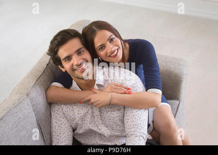 Portrait of a young woman embracing jeune homme de derrière Banque D'Images