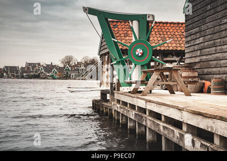 Vintage grue de bois monté près de moulin à vent. Ville de Zaanse Schans, attractions touristiques populaires des Pays-Bas. Banlieue d'Amsterdam Banque D'Images