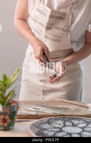 Feuilles à découper l'artiste du vitrail en petits carrés de mosaïque. Close-up Banque D'Images