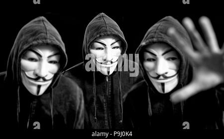 Les pirates anonymes portant des masques de Guy Fawkes et un coton ouaté noir Banque D'Images
