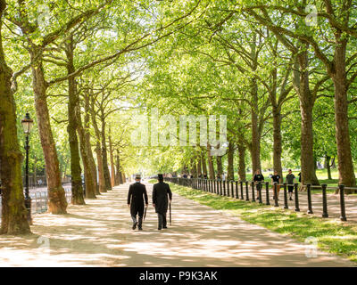 Les hommes en costume et haut de forme matin flânant dans Constitution Hill aux côtés de Green Park, London, UK Banque D'Images