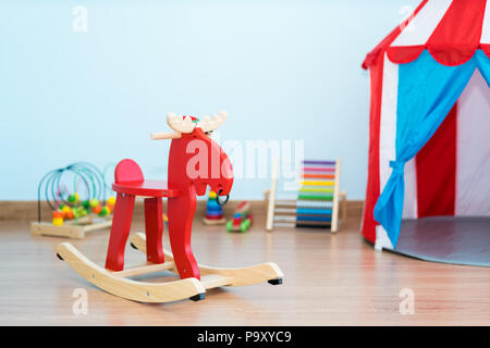 Rocking Red Deer près de jouet dans chambre de bébé à la maison. Banque D'Images