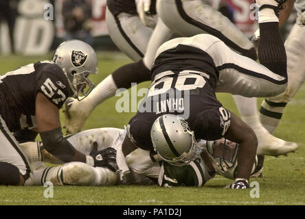 Oakland, Californie, USA. 12 Jan, 2003. Oakland Raiders défensive fin DeLawrence Grant (99) sacs New York Jets quarterback Chad Pennington (10) le dimanche, 12 janvier 2003, à Oakland, Californie. Les raiders défait les Jets 30-10 dans la division des séries éliminatoires. Crédit : Al Golub/ZUMA/Alamy Fil Live News Banque D'Images