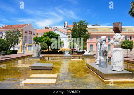 Des statues dans un bassin ornemental dans la Praca al Mutamid avec la cathédrale à l'arrière, Silves, Portugal, Europe. Banque D'Images