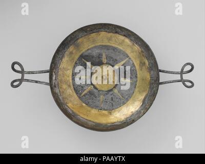 Silver-gilt cup (l'un d'une paire). Culture : le grec, l'italien. Dimensions : H. 2 1/2 in. (6,3 cm) ; diamètre 6 1/8 in. (15,5 cm) ; longueur poignées comprises 9 5/8 in. (24,5 cm). Date : 4ème-3ème siècle avant J.-C.. Les tasses sont décorées à l'intérieur avec une bande extérieure de dorures gravé de feuilles de lierre et de vrilles et, à l'intérieur d'une étoile, un médaillon central représentant Dionysos, le dieu du vin, avec son attribut habituel, un bout de lierre thyrse (personnel). Cette décoration est très approprié pour une paire de verres. Fait inhabituel, leurs coupes ont été élaborés à partir de minces feuilles d'argent plutôt que de Banque D'Images